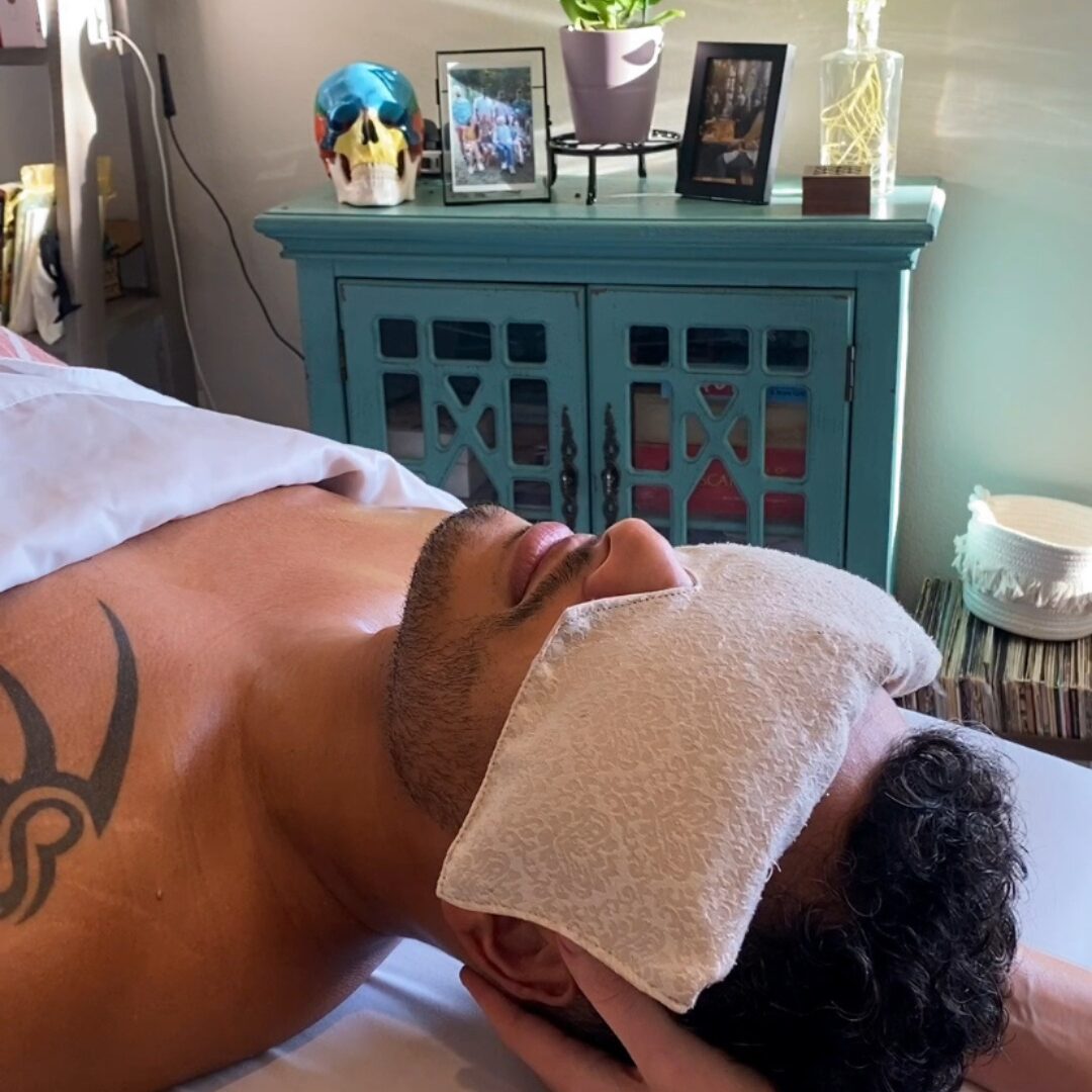 massage client with eye pillow